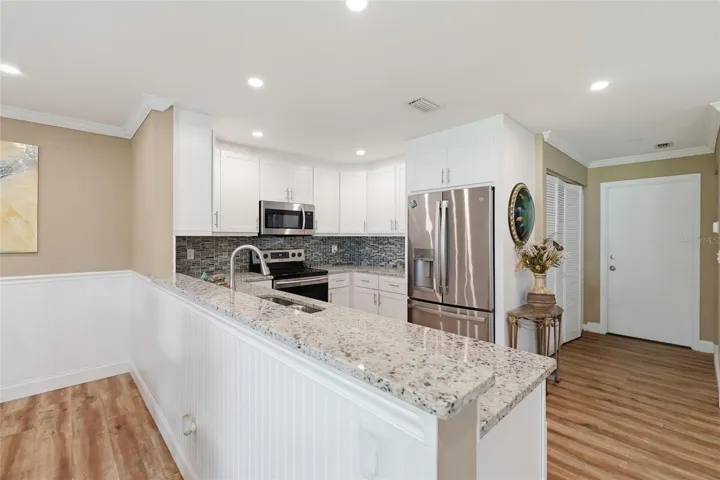 Open upgraded modern kitchen with stainless steel appliances