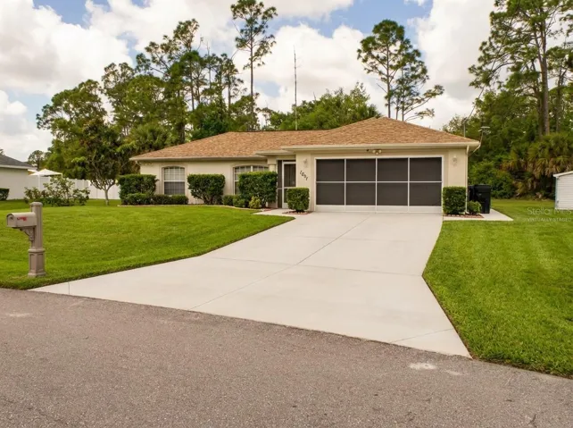 Welcome to your dream Florida lifestyle at this beautifully maintained North Port pool home, featuring a two-car garage and welcoming curb appeal. Perfectly situated on a spacious, oversized corner lot with no HOA, this inviting exterior sets the stage for relaxed and private Florida living. Virtually enhanced.