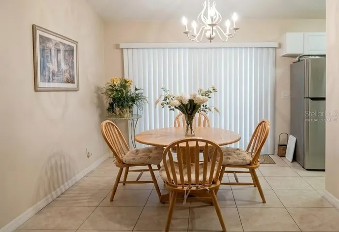 Enjoy family meals in this virtually staged open-concept dining room, offering gorgeous natural light and direct views of the private inground pool.
