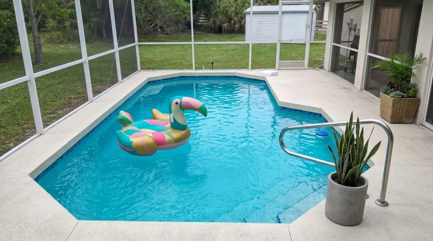 Dive into the ultimate Florida lifestyle with this stunning private inground pool, surrounded by a spacious sun deck perfect for lounging.