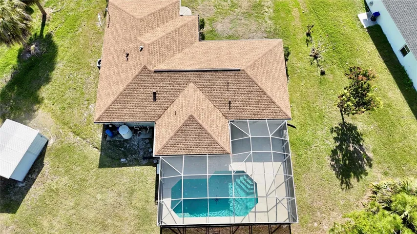 View the impressive footprint of this North Port pool home from above, highlighting the expansive, oversized corner lot and ultimate privacy with no HOA.