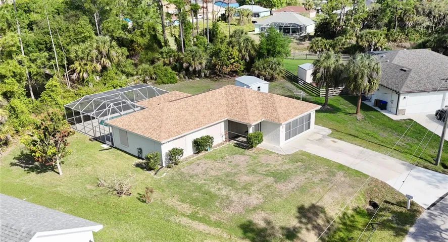 This aerial perspective showcases the home's fantastic location in a peaceful neighborhood, offering a serene Florida lifestyle just minutes from local amenities.