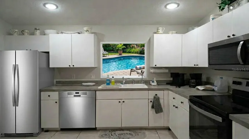Cook and entertain in style with brand-new stainless steel appliances in this thoughtfully designed open-concept kitchen, complete with tile flooring and abundant counter space.