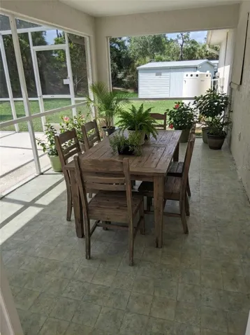Entertain year-round on the expansive screened-in lanai, offering a shaded, breezy retreat that seamlessly blends indoor and outdoor living.