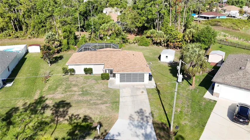 Take in the complete picture of this beautiful property, featuring a private pool oasis and generous oversized lot  that backs up to a lush green space in North Port Florida.