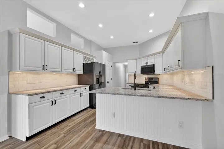 Almost new kitchen with granite, black ss appliances and new fixtures
