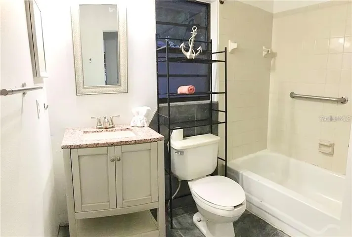 Shared bathroom with bathtub