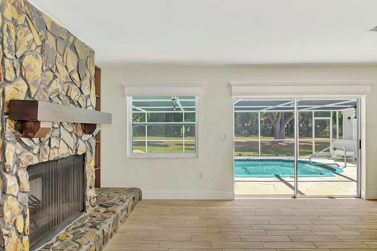 Wood burning stone fireplace out to the pool!