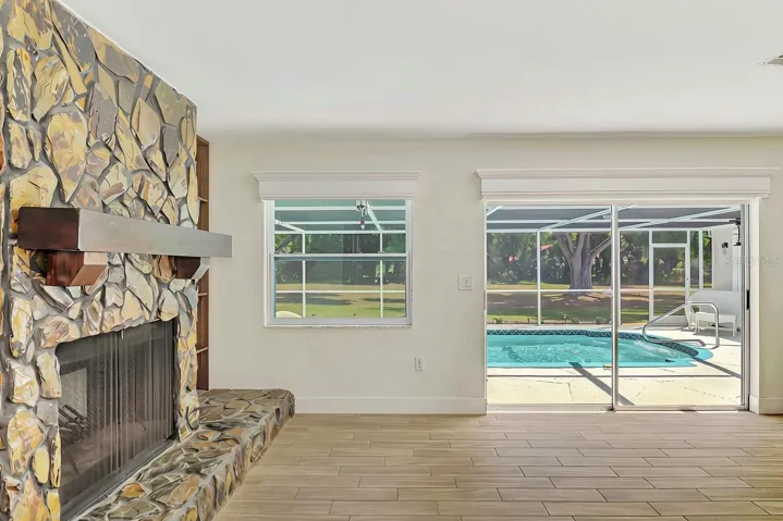 Wood burning stone fireplace out to the pool!