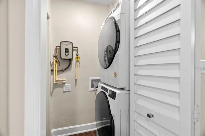 Indoor washer/dryer and a Rheem tankless hot water heater.
