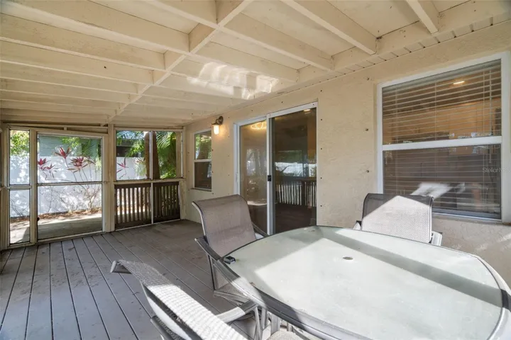 Life extends outdoors with a screened Florida room.