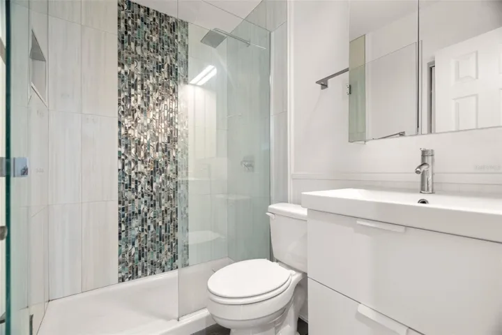 Stylish bathroom with walk in shower.