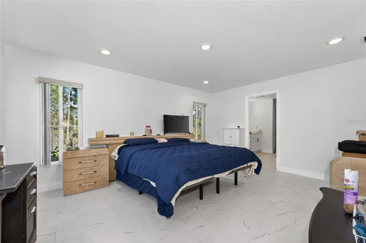PRIMARY BEDROOM SPACE WITH DOOR TO PRIVATE BATHROOM