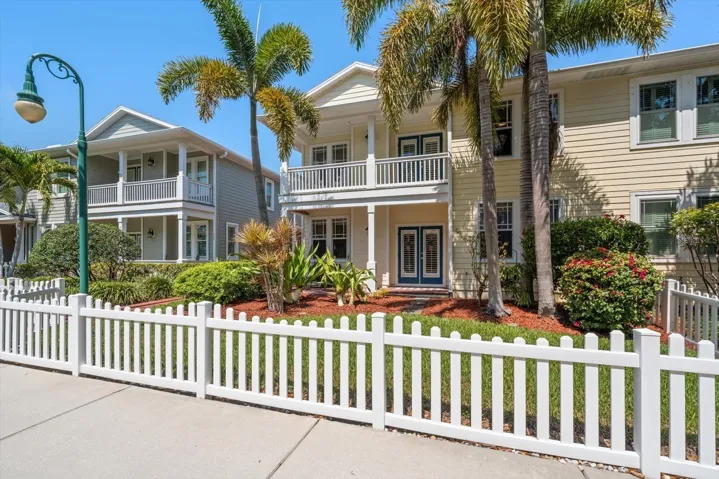 Front of unit, fenced front yard, large covered patio, french doors