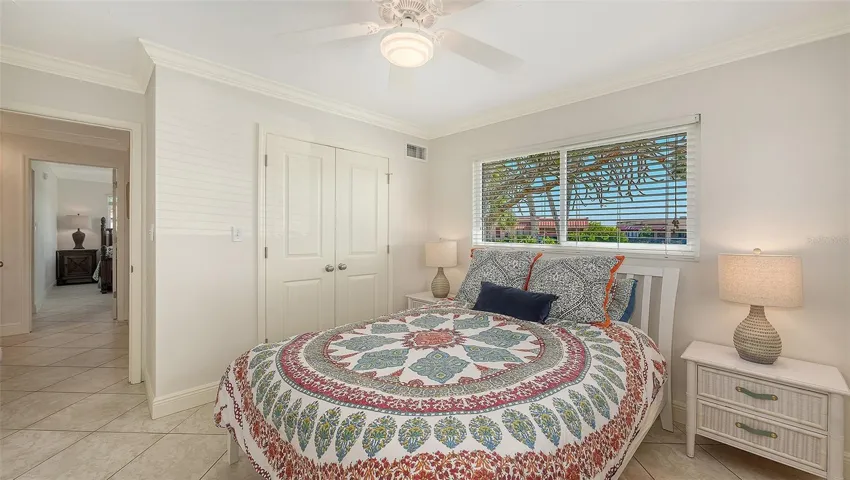 Second bedroom with windows overlooking side yard