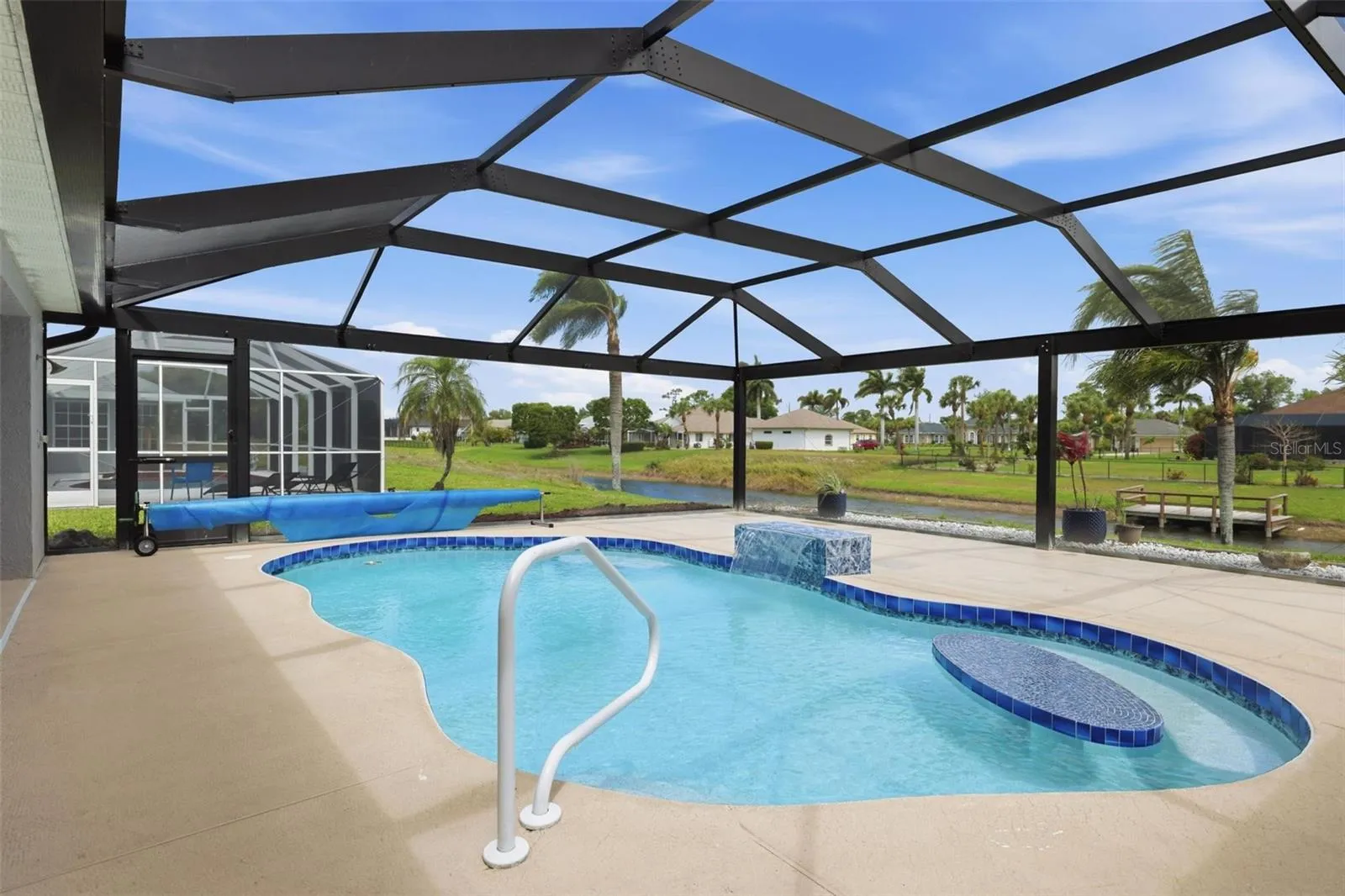 Spacious screened lanai showcasing newly redone pool and open surrounding views