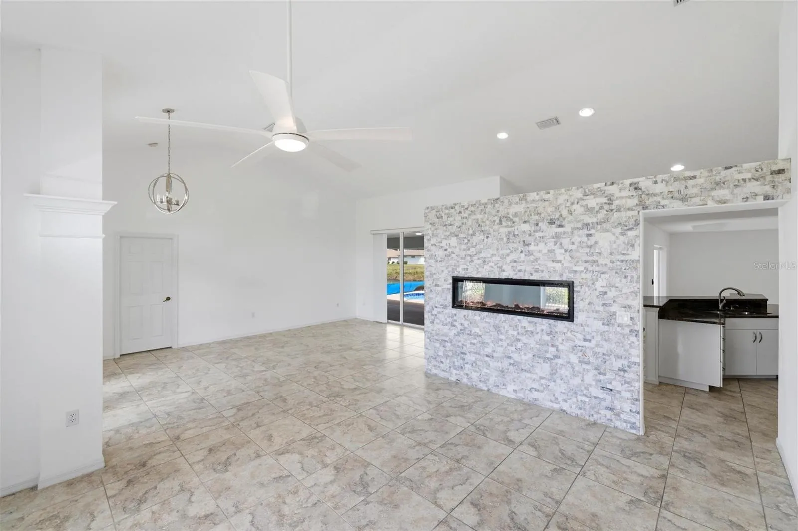Open living space with tile floors, recessed lighting, and clean neutral tones