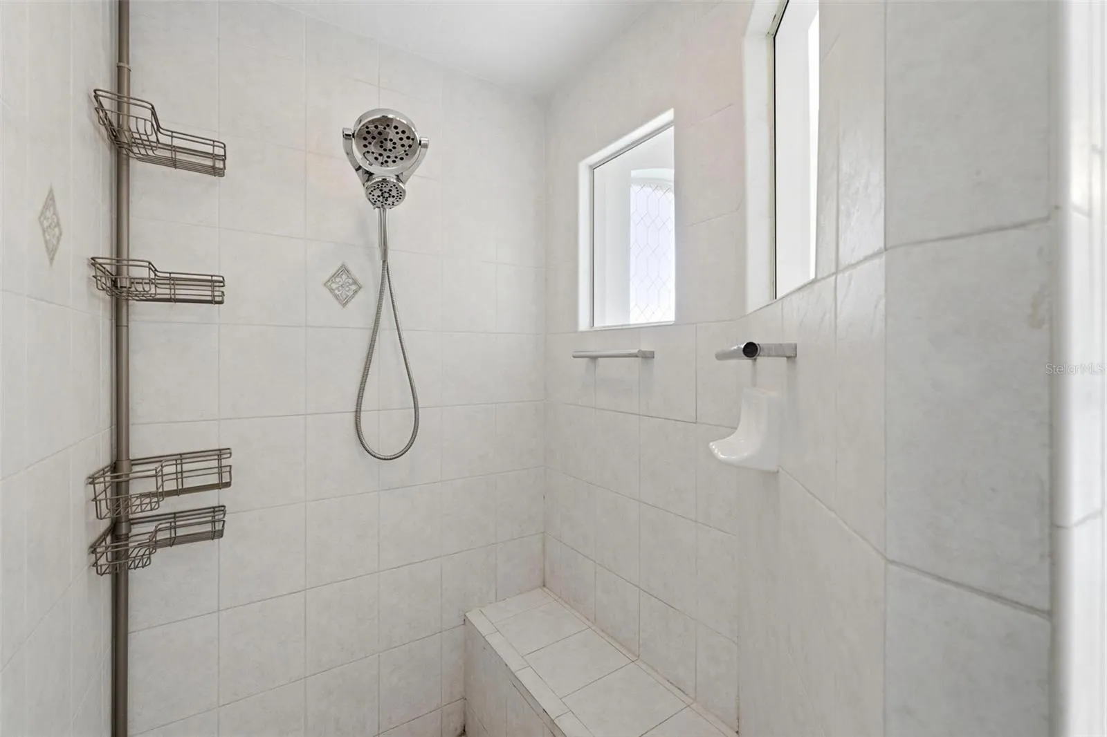 Walk-in shower with glass enclosure, tile surround, and updated modern fixtures