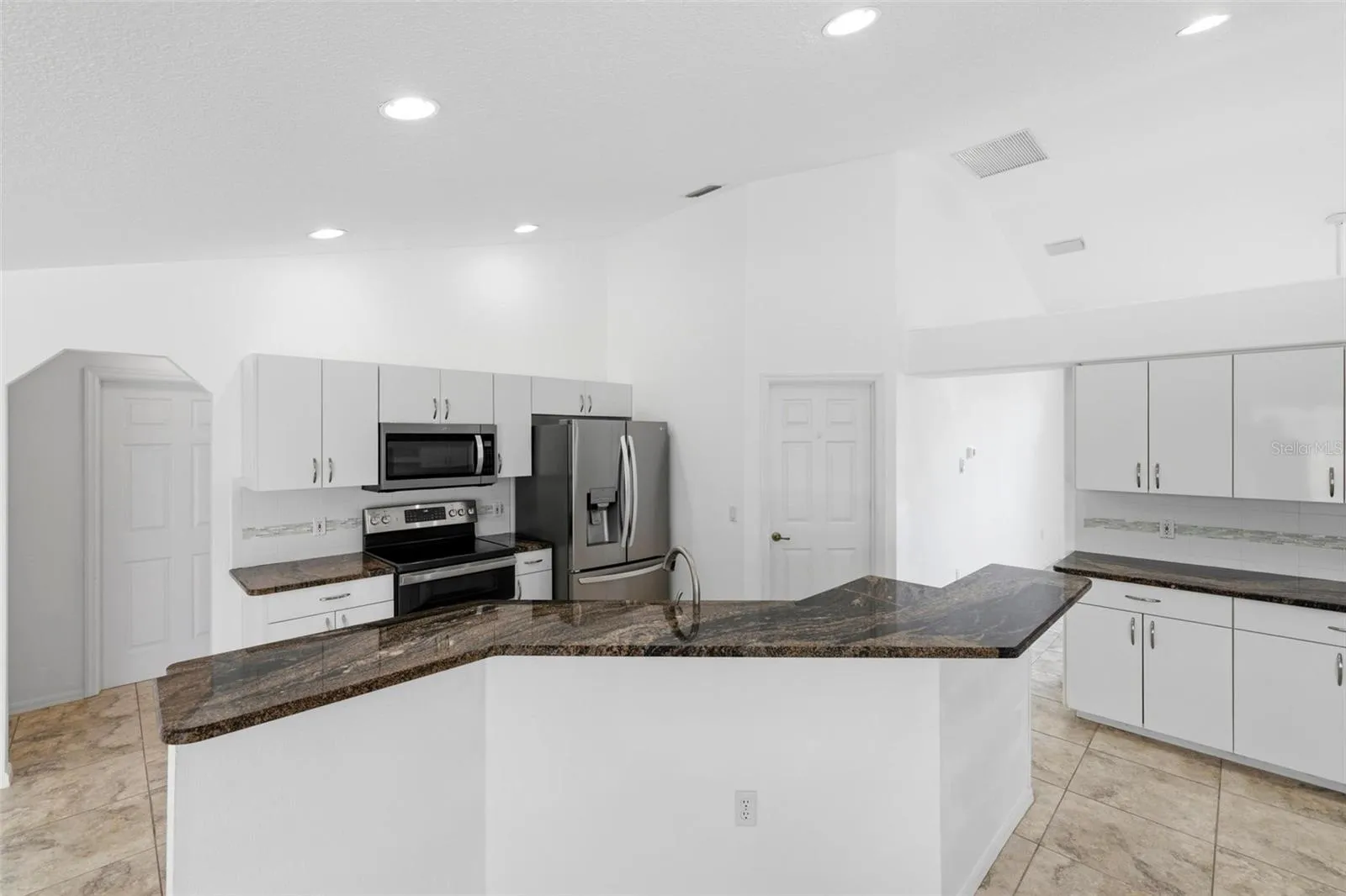Bright kitchen with white cabinetry, new 2024 appliances, and move-in ready condition