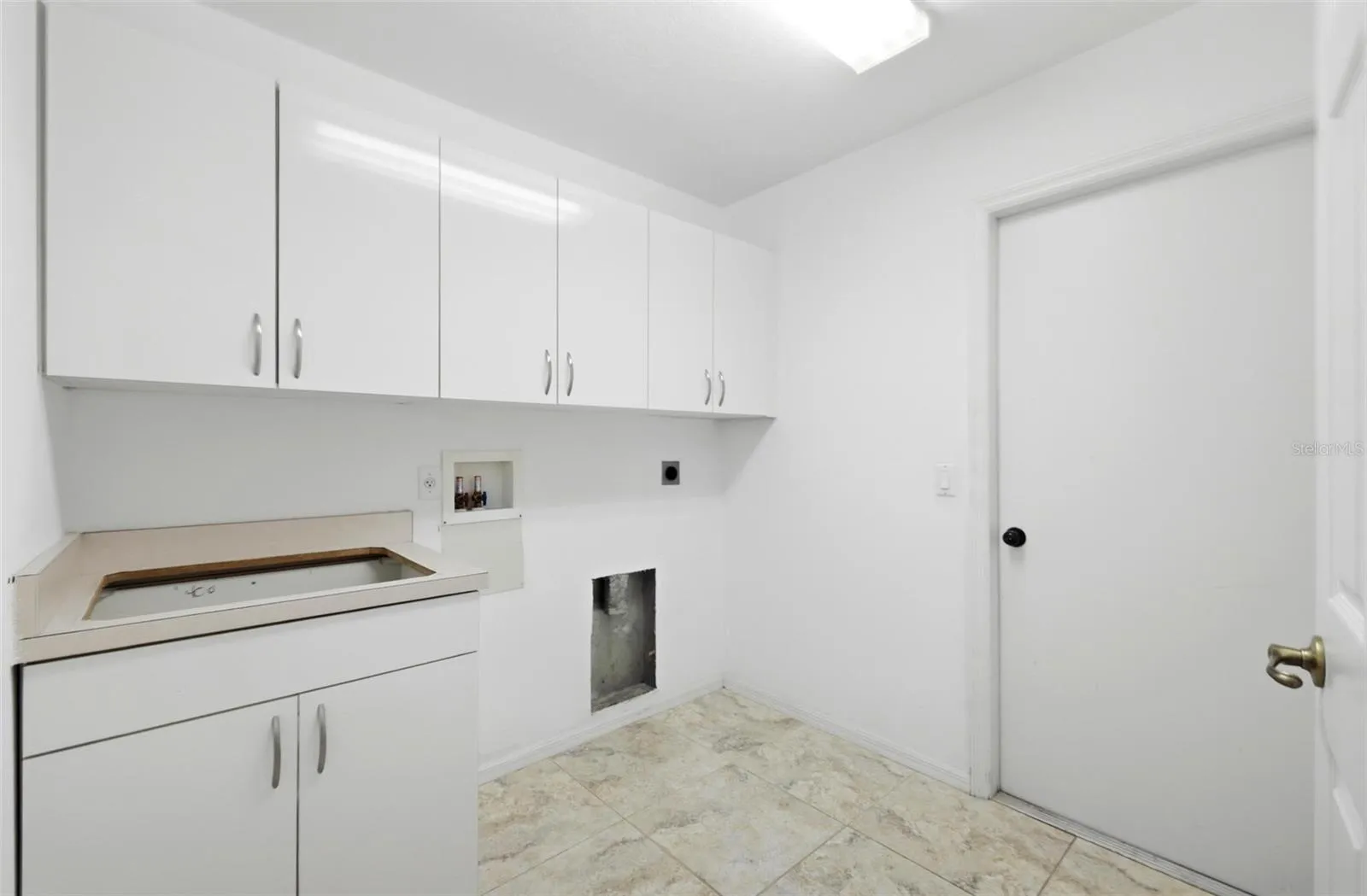 Spacious laundry room with ample storage and move-in ready condition, includes new washer/dryer (2024)