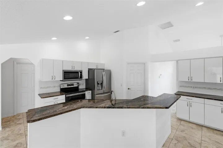 Bright kitchen with white cabinetry, new 2024 appliances, and move-in ready condition