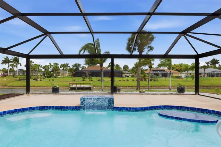Bright pool interior with panoramic screen enclosure offering seamless indoor-outdoor living