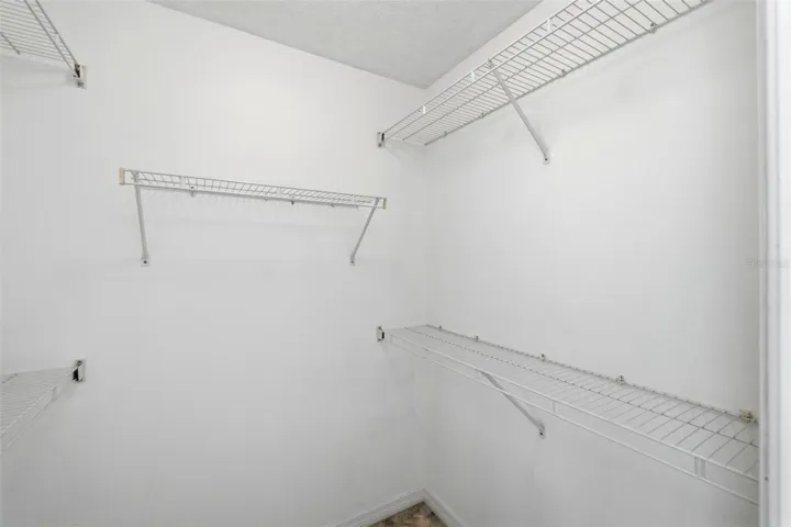Spacious walk-in closet with ample shelving and plenty of organized storage space
