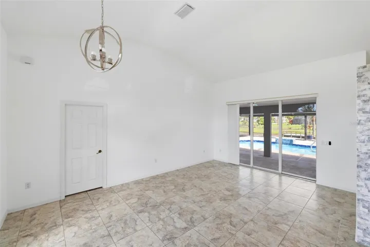 Bright open room with large windows, tile floors, and move-in ready condition