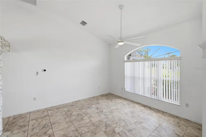 Large open room with tile floors, abundant natural light, and move-in ready finishes