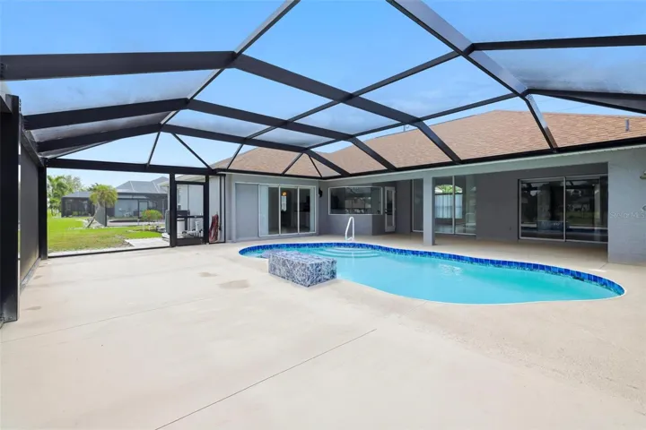 Large screened lanai with heated pool, spa, and plenty of room for entertaining