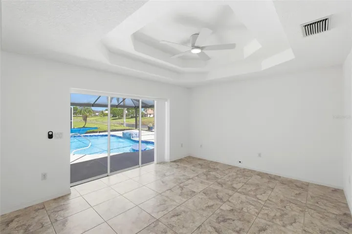 Bright living and sitting area just off the kitchen with coffered ceiling and recessed lightin