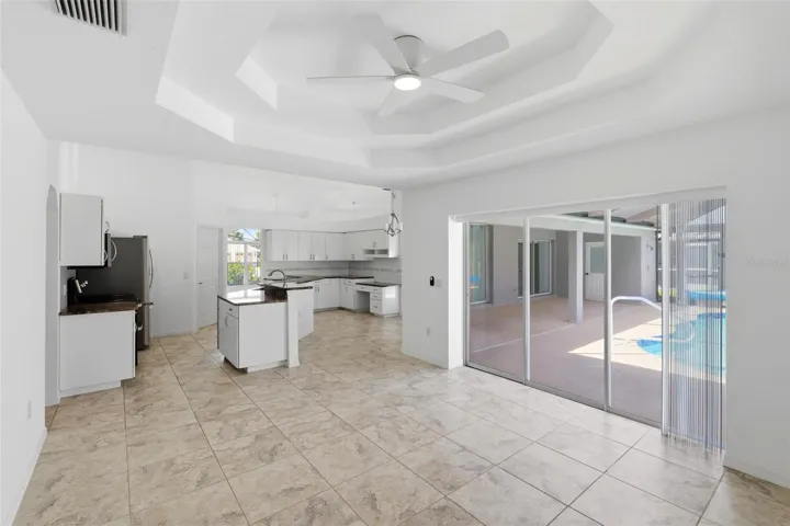 Gourmet kitchen with all-new 2024 stainless appliances and views to pool beyond