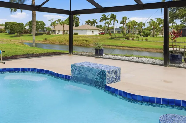 Newly redone chlorine pool (2025) with resort-style screened enclosure and ample deck