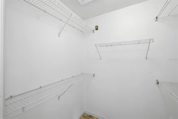 Large walk-in closet with rod and shelf system, ready for your personal touch