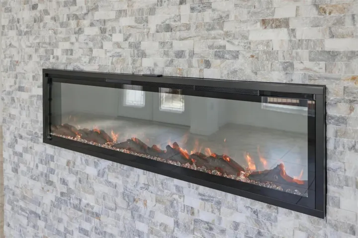 Stunning floor-to-ceiling linear fireplace with stone surround as a dramatic focal point