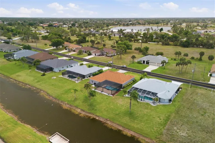 Aerial perspective showing owned solar panels (2025), new roof (2023), and pool area