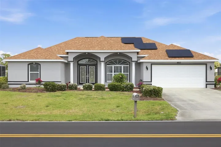 Freshly painted grey exterior on this move-in ready 3/2.5/2 single-family home