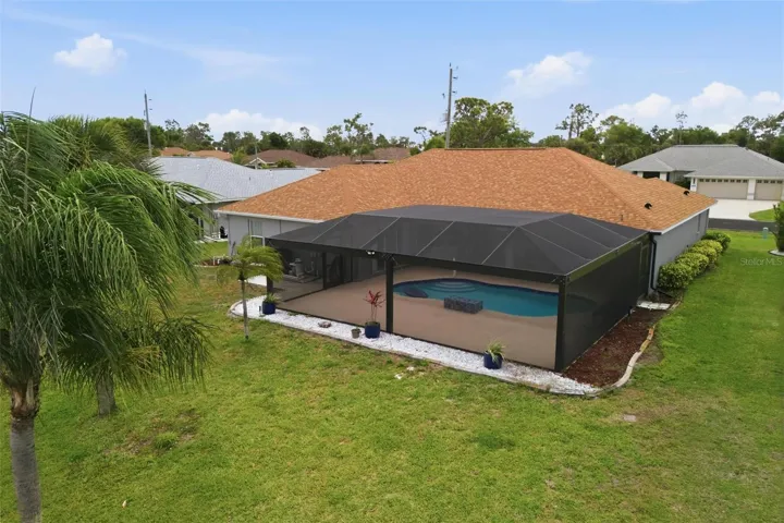 Bird's-eye view showcasing home layout, newly redone pool, and landscaped grounds