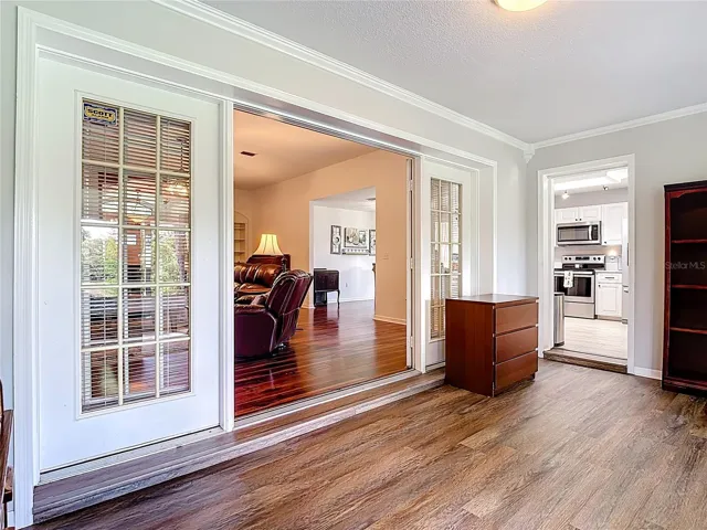 Florida Room with double french doors and entry to kitchen