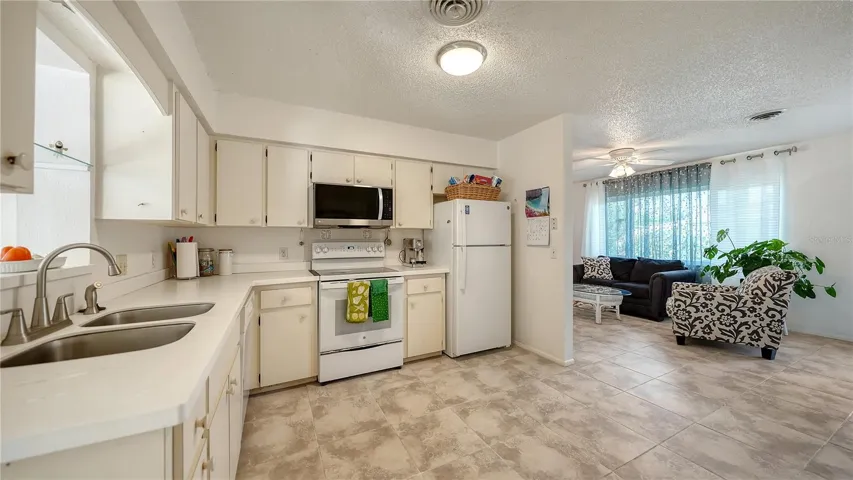 Kitchen with partial living room view