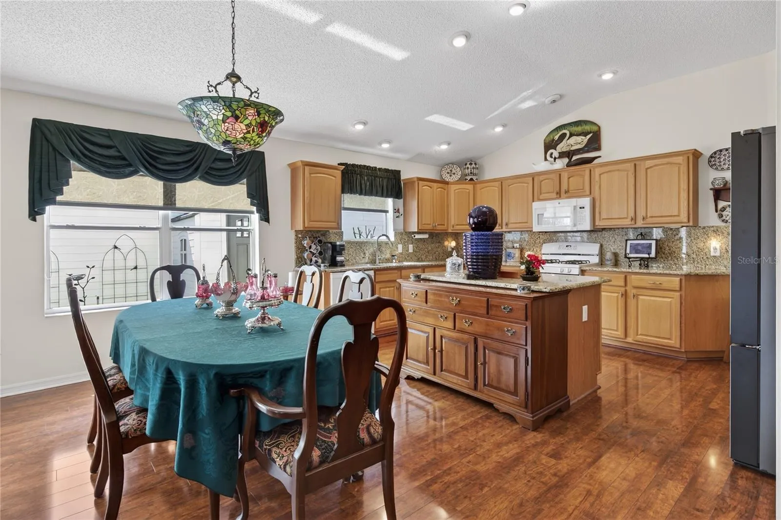 SPACOUS DINING ROOM AND KITCHEN INCLUDES SOLAR SHADES