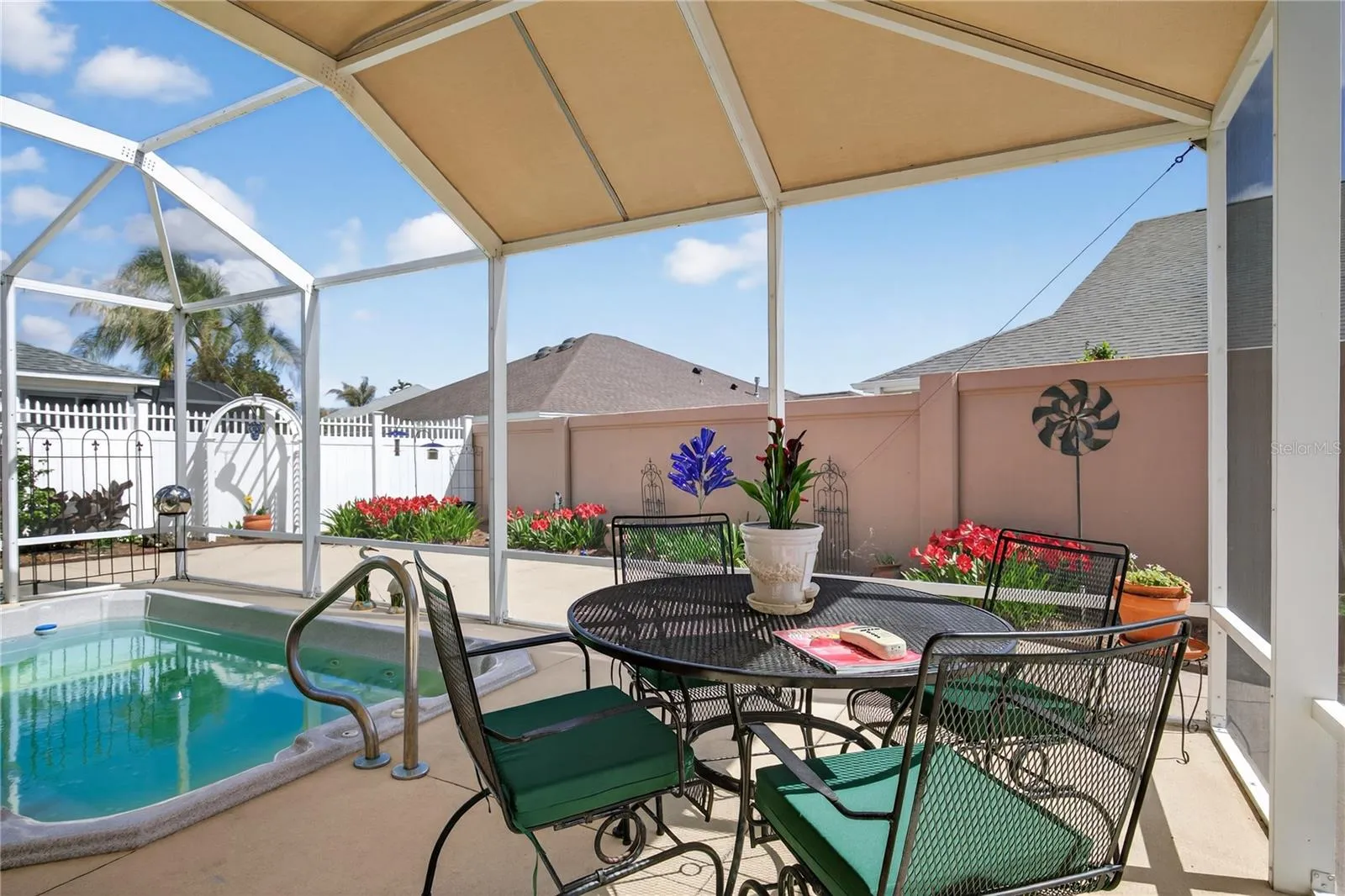 THE HEATED SWIM SPA IS SCREENED IN AND HAS A CANOPY FOR ADDED SHADE