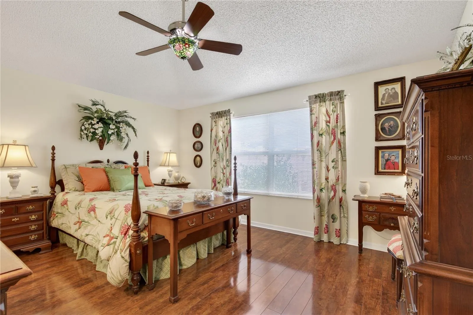 The primary suite offers delightful courtyard views, providing a serene connection to the lush, inviting tropical landscape that beautifully frames the property.