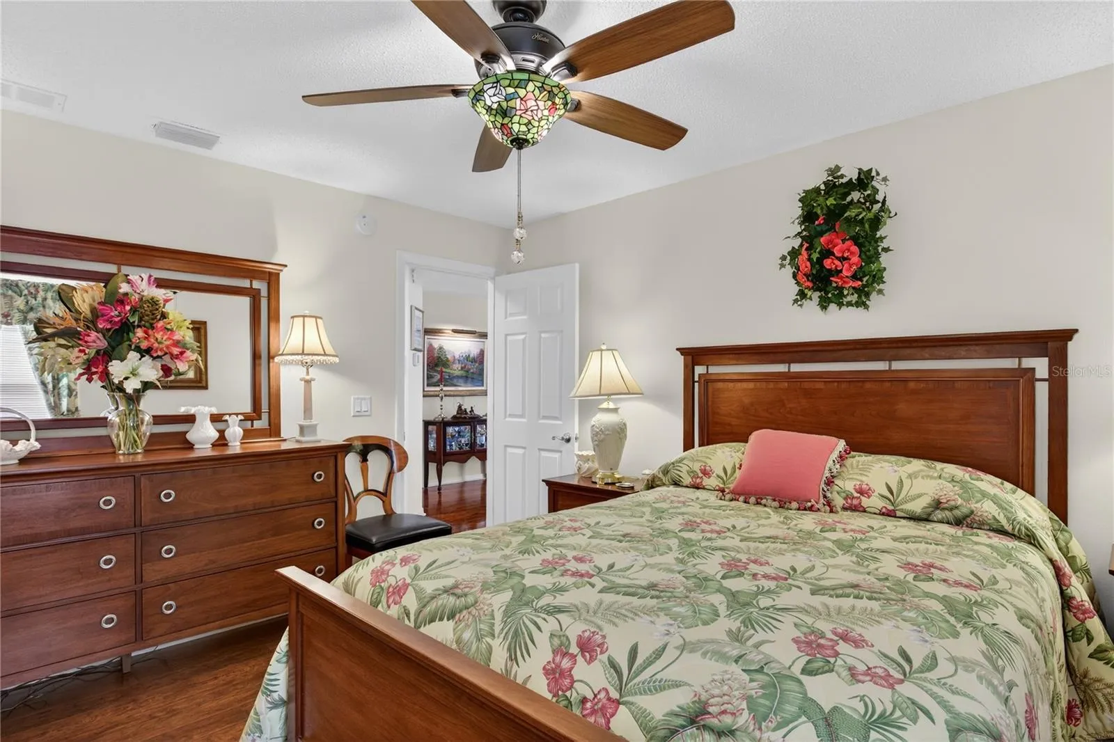NOTICE THE ELEGANT UPDATED CEILING FAN AND TIFFANY GLASS LIGHT SHADE