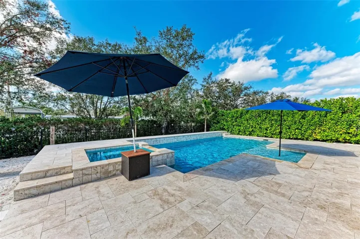 Heated, saltwater pool with spa and sunshelf.
