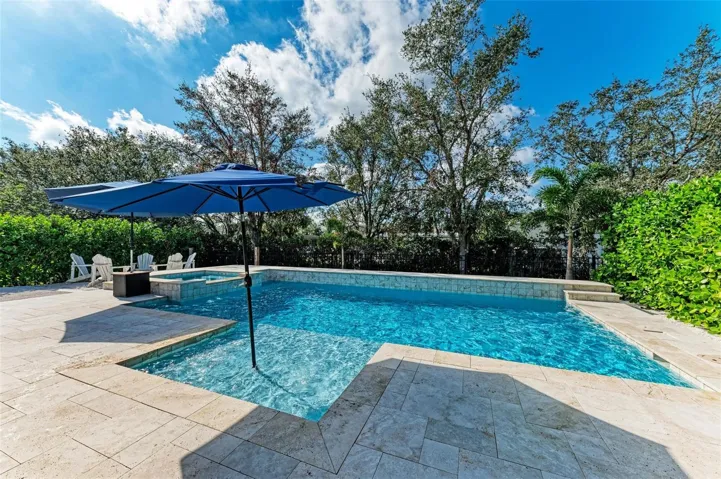 Heated, saltwater pool with spa and sunshelf.
