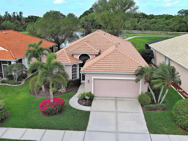 Welcome to the epitome of a perfect Florida home, complete with a tile roof and tropical landscaping.