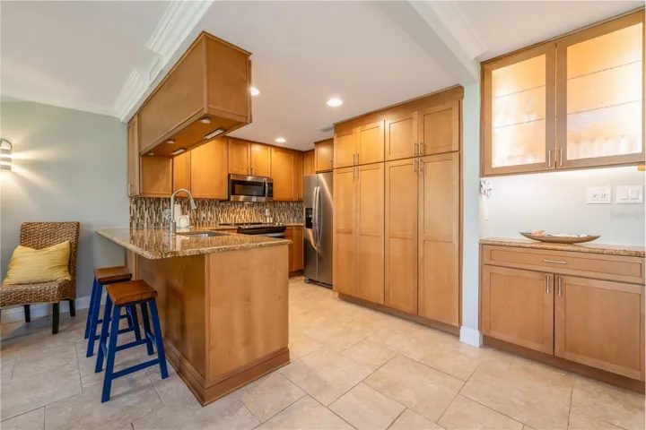 Gourmet kitchen with newer cabinets, granite counters & SS appliances.