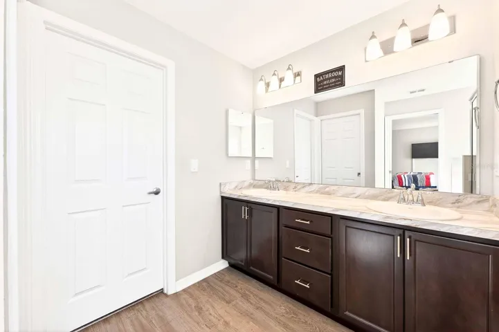 The Primary EN SUITE BATH is complete with dual sinks, a garden tub, a step-in shower, a private water closet, and a SPACIOUS WALK-IN CLOSET.