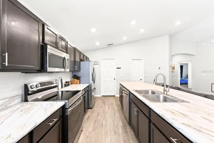 The spacious Kitchen is a welcoming hub for gathering with family and friends.